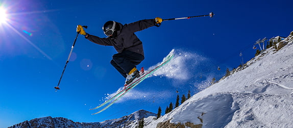 An athlete skis down a snow-filled mountain