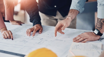 a construction crew looking at schematics 