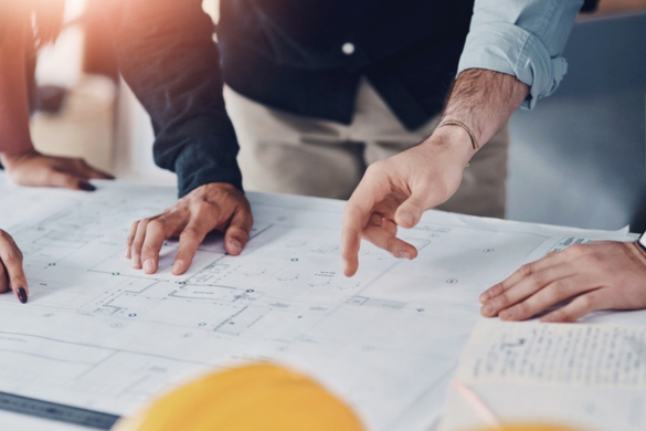 a construction crew looking at a schematic 